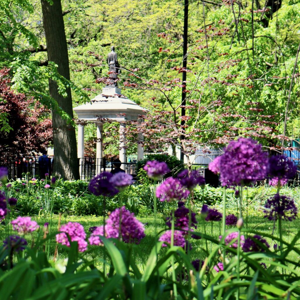 photo of the Temperance Fountain in Tompkins Square Park with flowers on the foreground